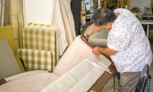 Craftsman reupholstering in workshop